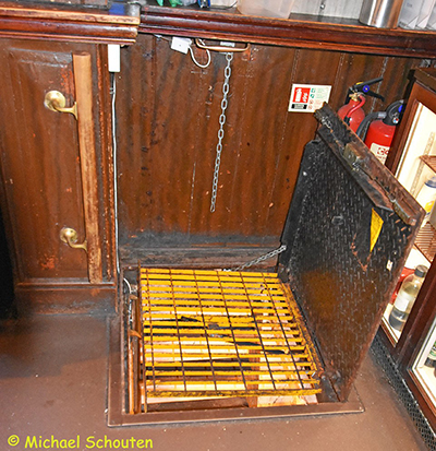 Trapdoor to Cellar Behind Bar.  by Michael Schouten. Published on 